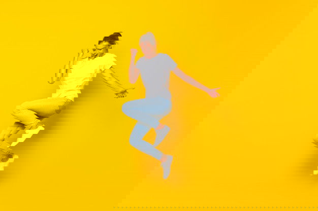 Young Woman Jumping Isolated Yellow Wall 1368 43192 1