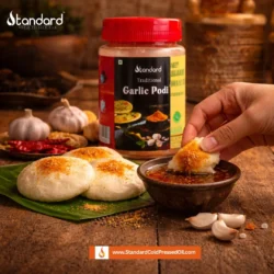 Garlic podi served with idli and sesame oil on a wooden table, traditional South Indian breakfast with spicy chutney powder