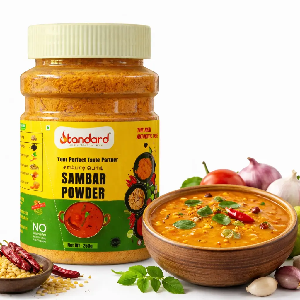 Standard Sambar Powder 250g jar with freshly prepared South Indian sambar in a bowl and spices on white background.