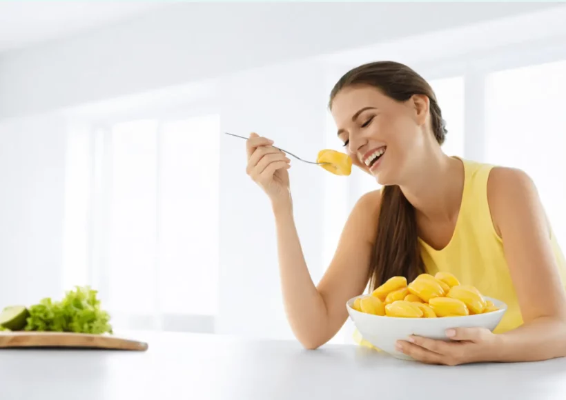 Smiling Woman Enjoying Fresh Ripe Jackfruit From A Bowl In A Bright, Healthy Kitchen Setting